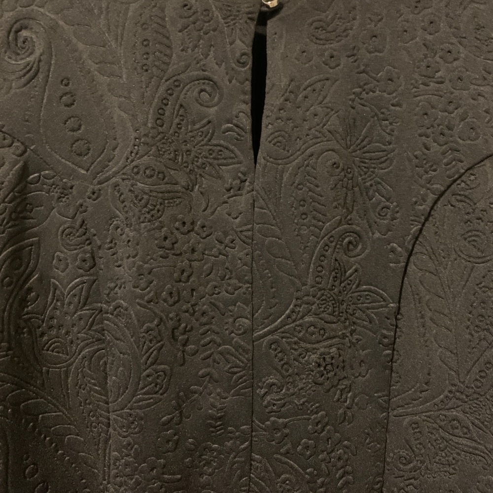 Black peplum blouse with detailed fabric